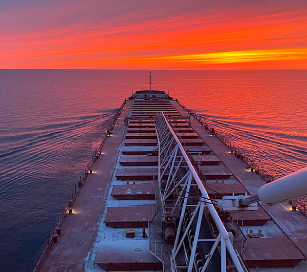 View of the sunset over the water on a freighter